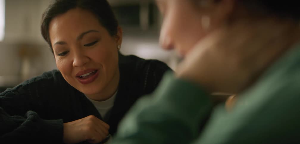 Mother helps her daughter with her homework