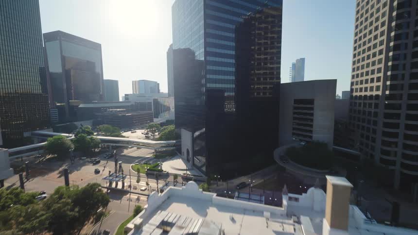 Downtown Dallas with tall buildings and spacious parking lots