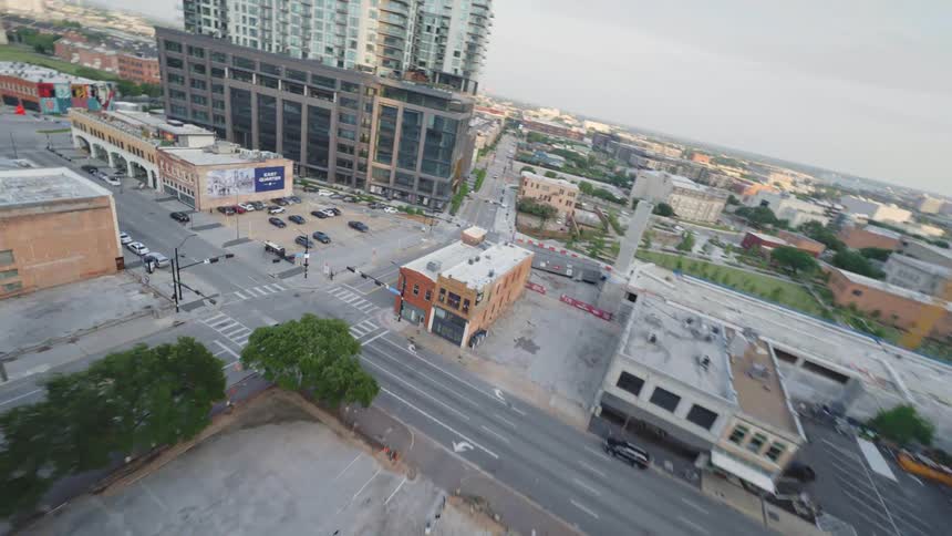 Aerial panorama of a metropolis with urban and commercial buildings during the day with a partially cloudy sky