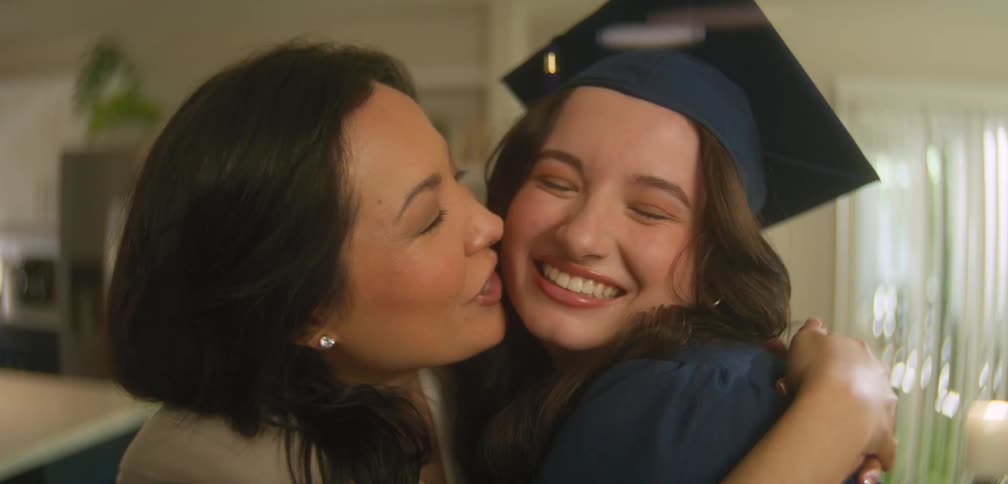 Mother and daughter are hugging on graduation day