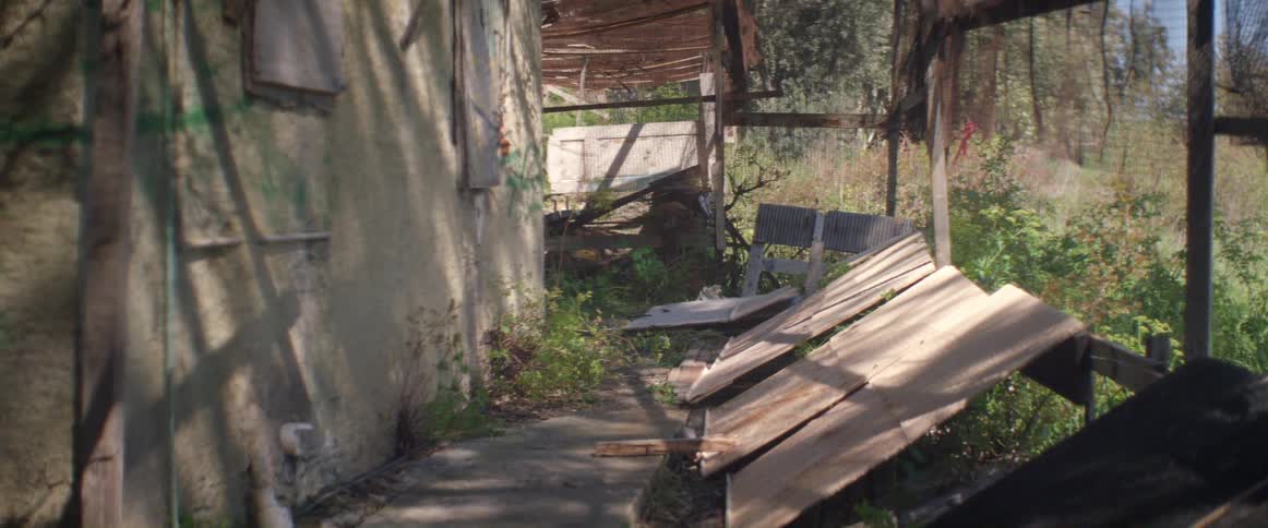 Debris lies on the ground near a building