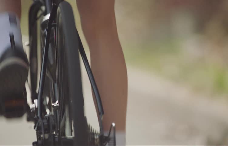 A person is pedaling on their bike and moving fast