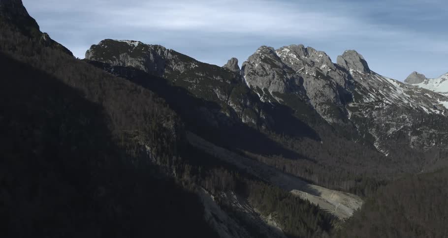 Aerial view of a rugged mountain landscape with snowcapped peaks
