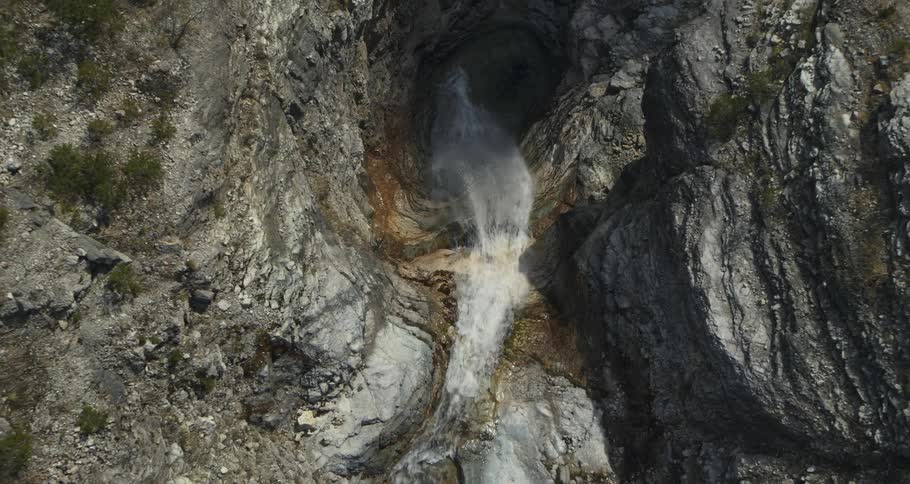 Aerial view of a waterfall amidst the rocks