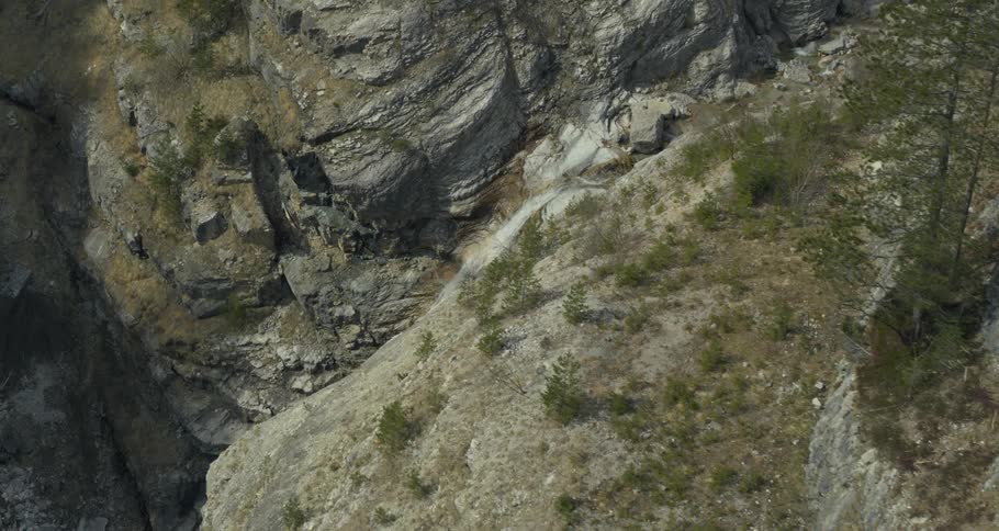Aerial panorama of a waterfall in the middle of mountain rocks