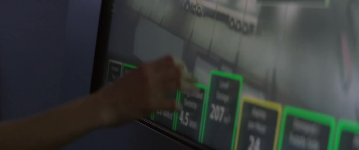 Woman manipulates the image of building on a touchscreen