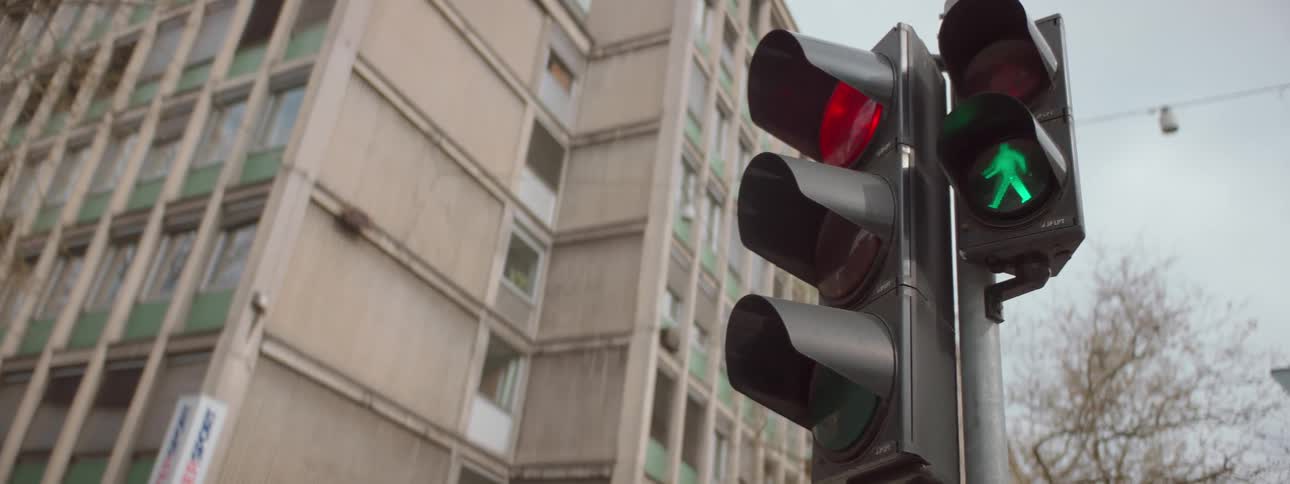 A traffic light is illuminated as the pedestrian crossing light changes