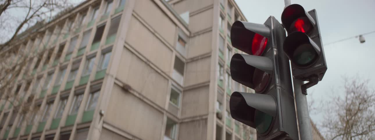 A traffic light in a city is signaling people to stop