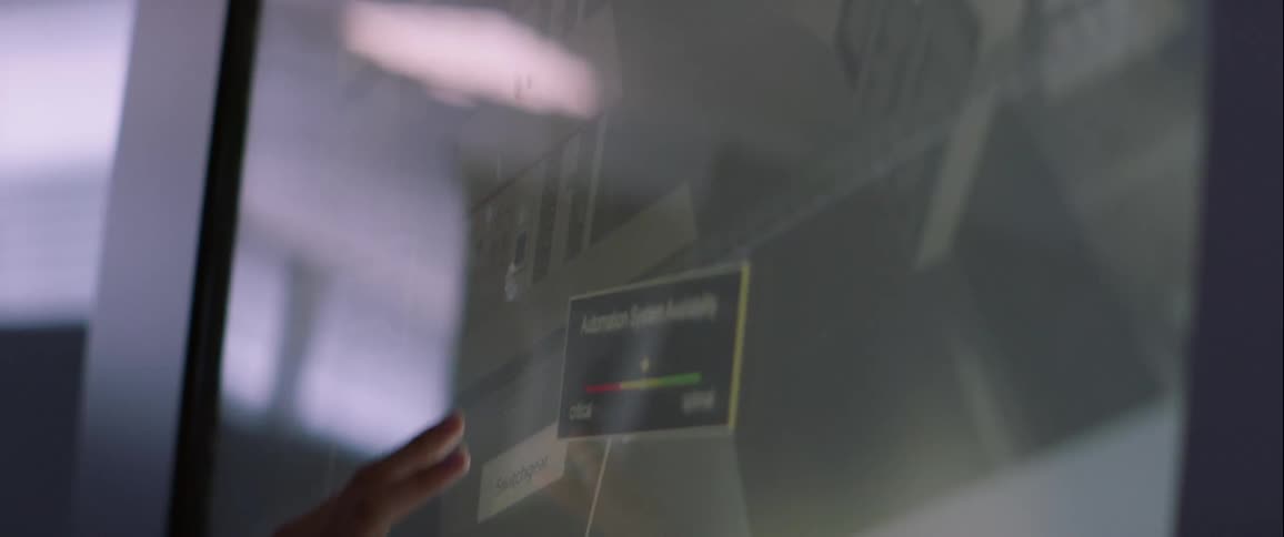 A hand adjusting and moving 3d objects on a large touchscreen