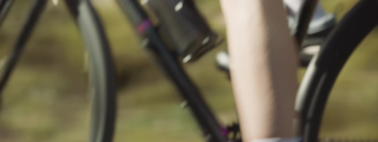 A person is pedaling on their bike during spring time