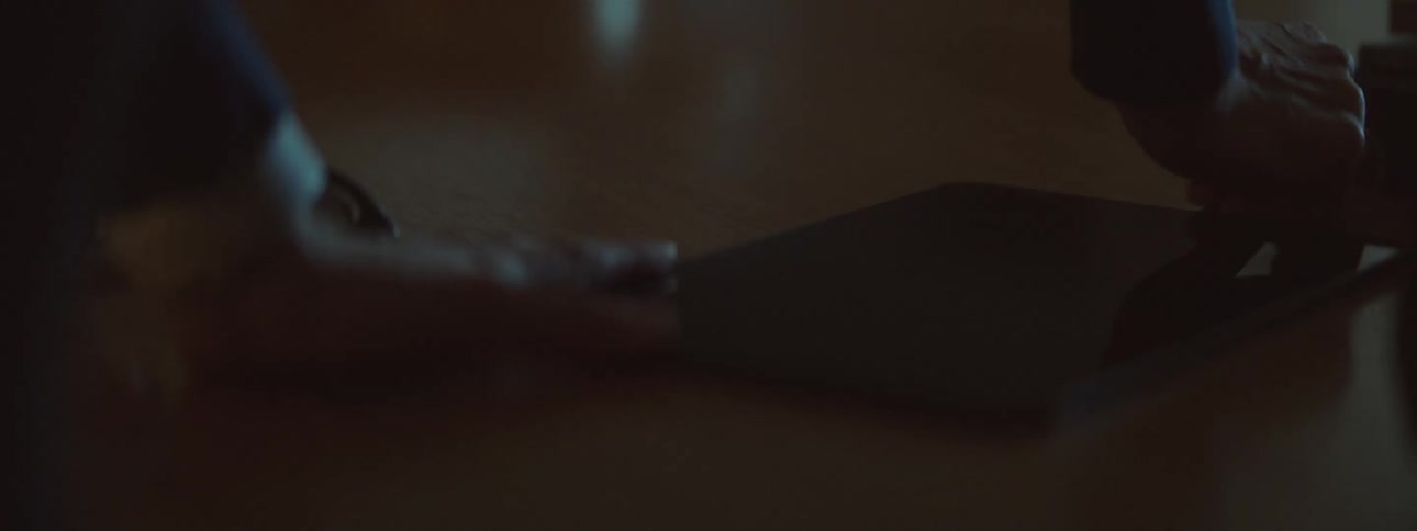Person unplugs a tablet and picks it up off the table