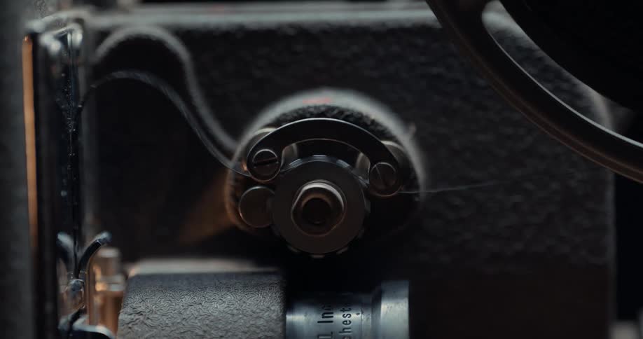 Close up of the spinning gears of a film projector