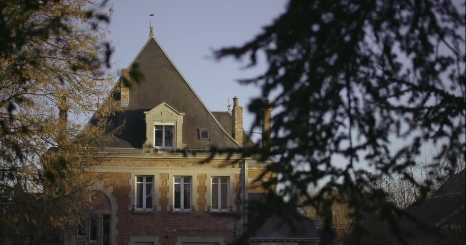 Upper part of a house seen against a clear blue sky