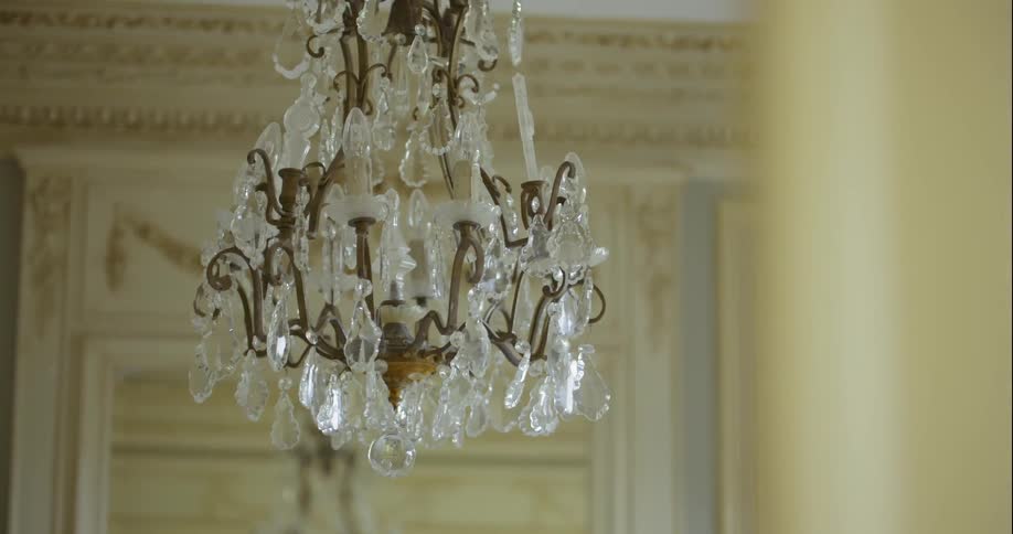 Chandelier hanging from ceiling in victorian style home