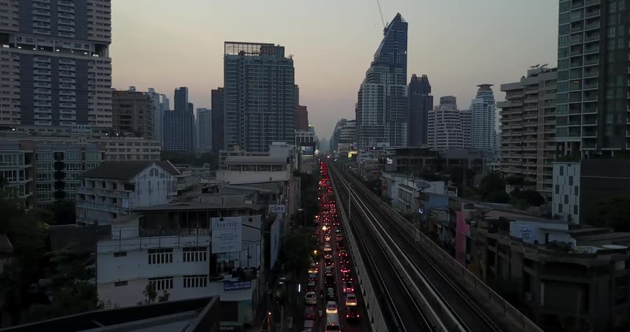 Heavy traffic is backed up in a city at dusk