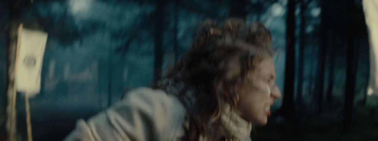 A person in white clothes moving downwards and he is in a forest