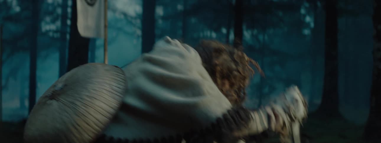 A person moves to plunge a blade in someone on the ground