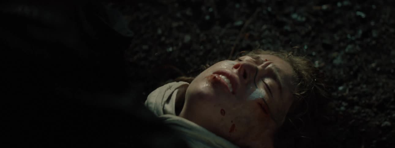 Person lying on the floor with blood stains on their face and weak