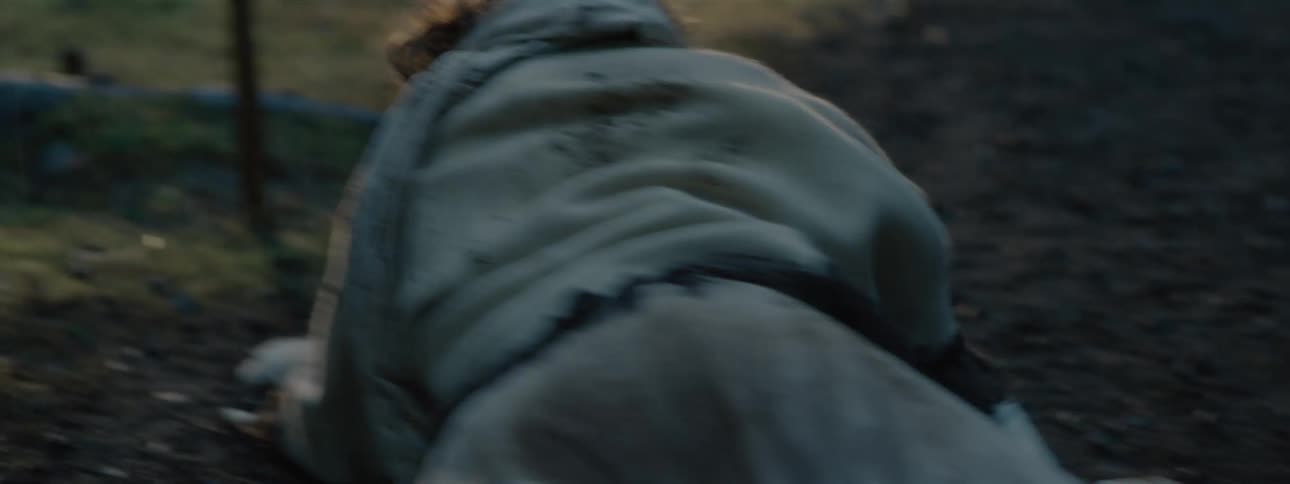 Person holding a sword and crawling on a grassy floor