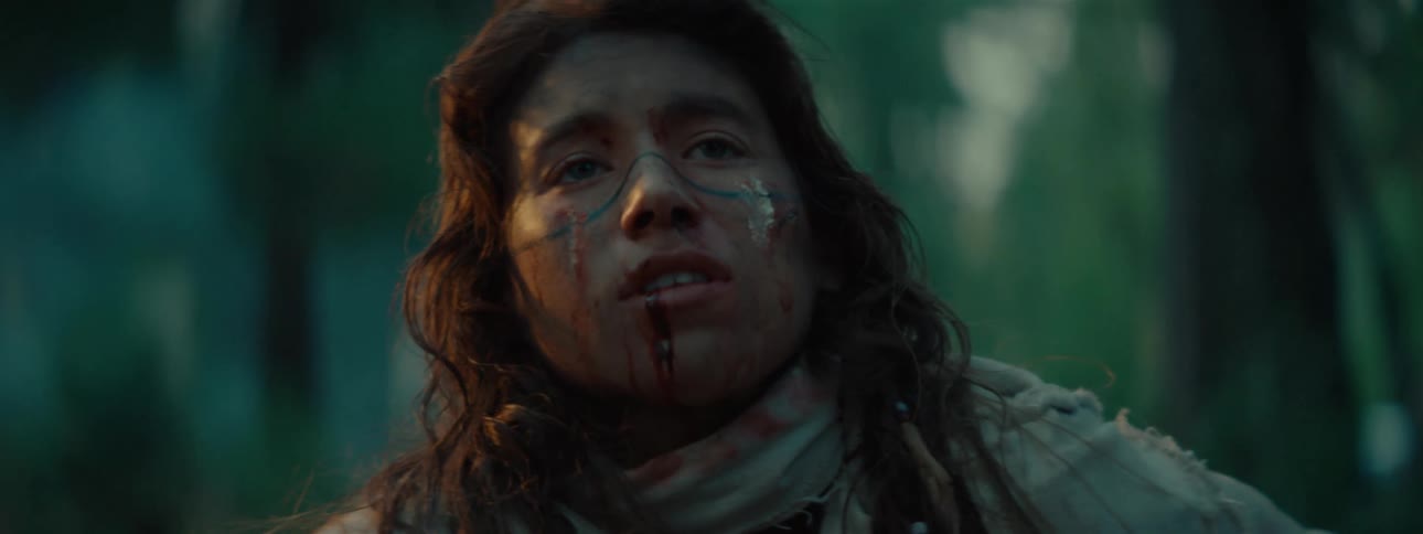 Portrait of a person tired and in pain taking a deep breath while standing in a forest