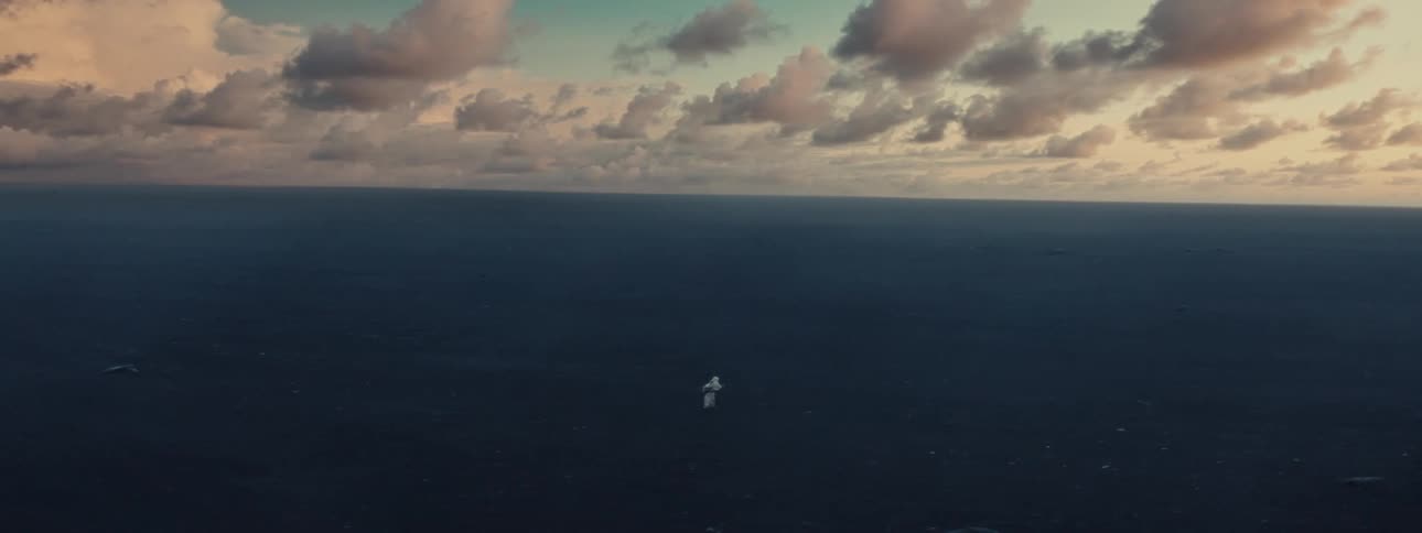 A person walking in an environment with dark ground and flat horizon