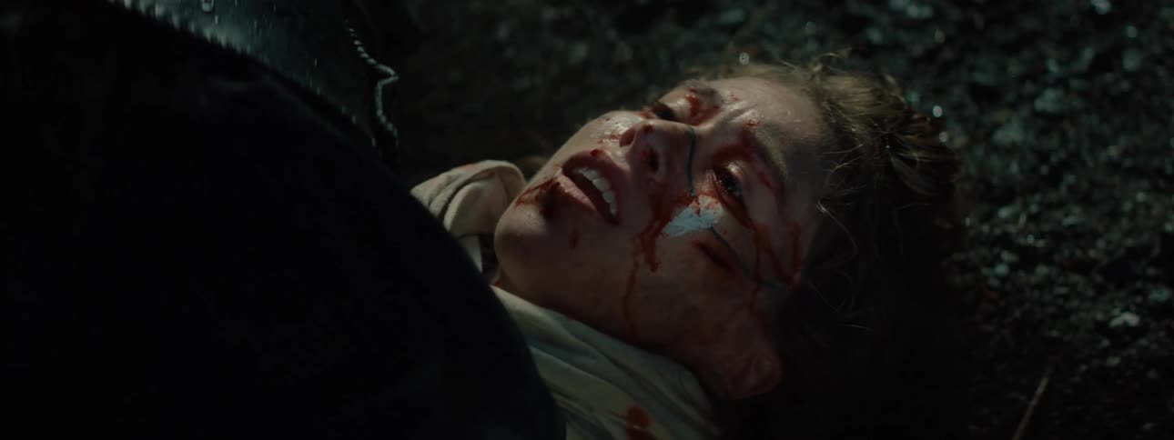 A woman is injured and bleeding on the ground