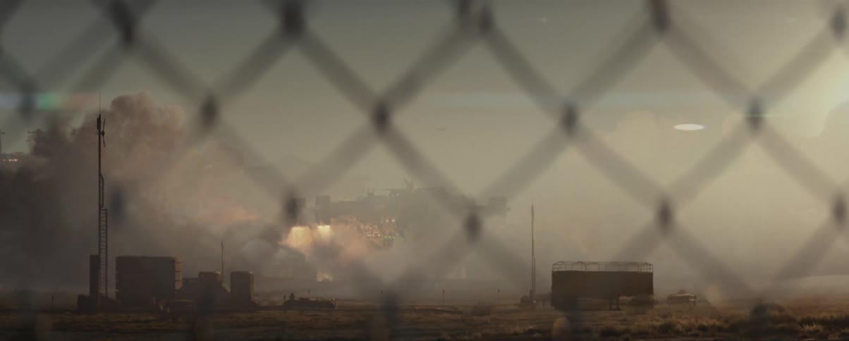 A spaceship takes off behind the fence