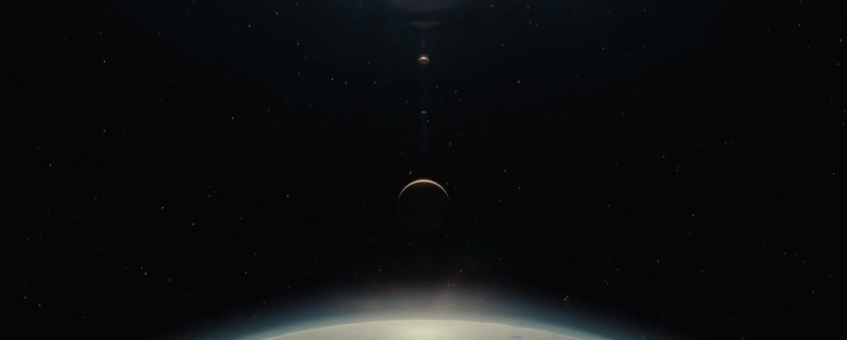 A view from space with three planets lined up and one of them that is further down is shining brightly
