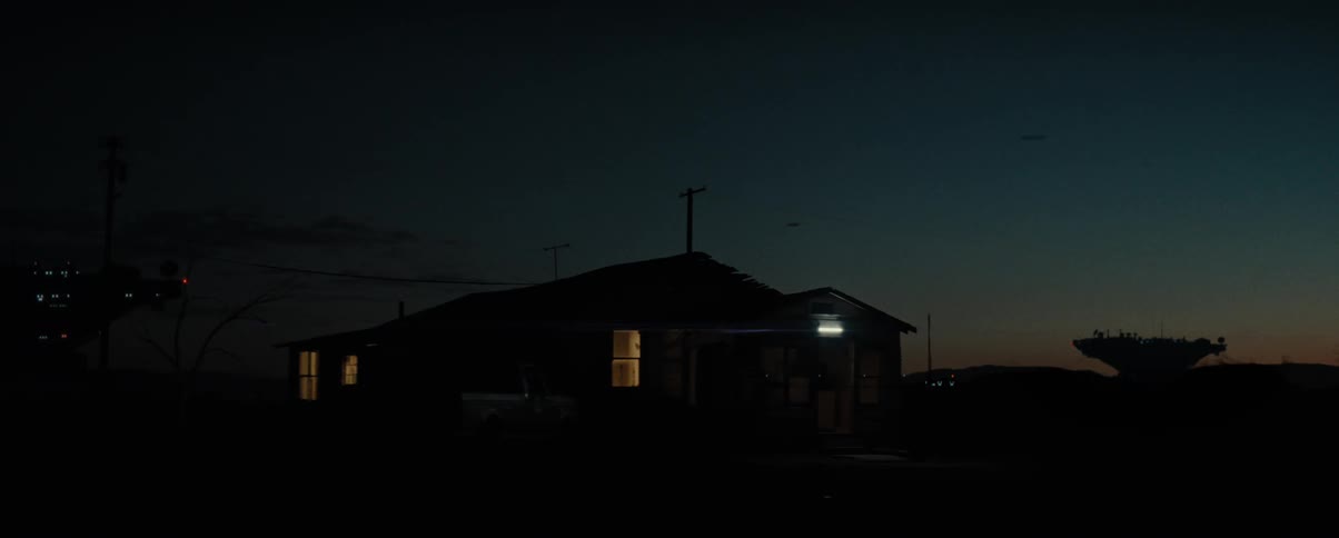 View of a house at night with the orange horizon