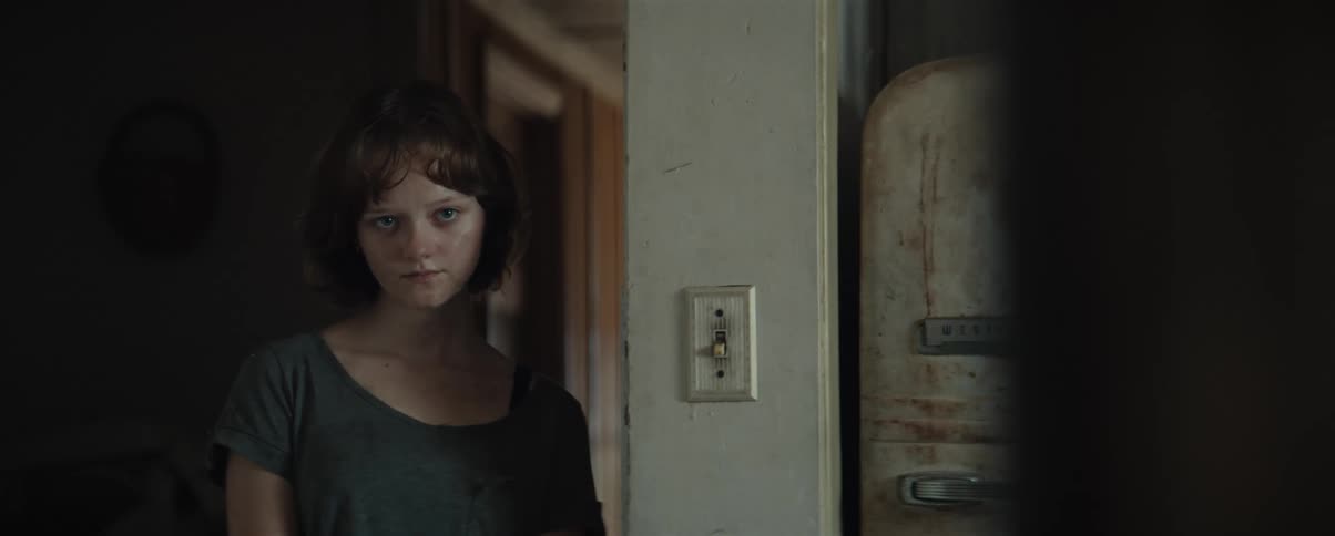 The girl is standing in the hallway