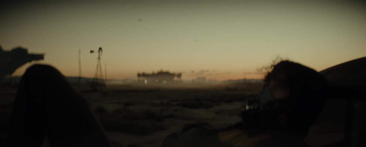 Dusk scene with silhouettes of structures and a spaceship in the background in a spaceport