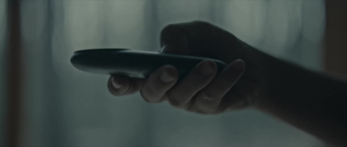 Hand holding a controller and clicking