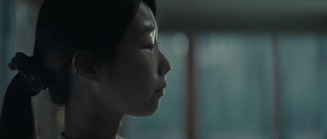 Side portrait of a young woman crying