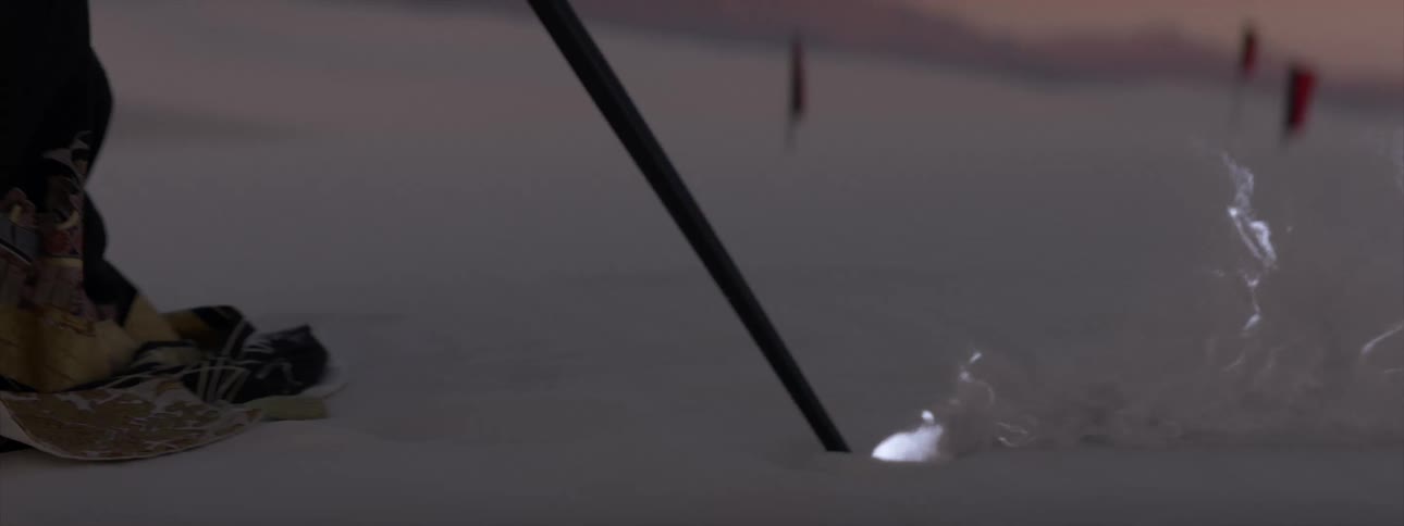 Magic staff being dragged across the desert sand and releasing glowing smoke