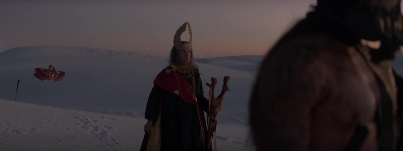 People in desert mountains with sand dunes representing a kingdom