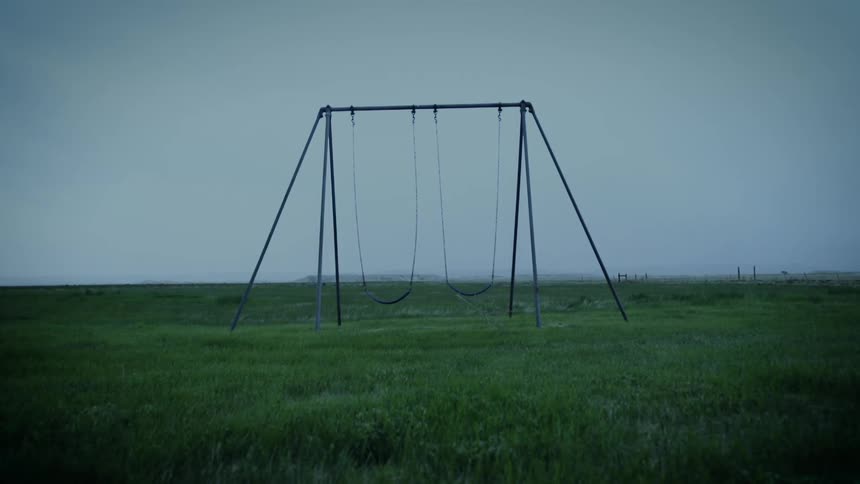 Swings on a swing set move in the wind