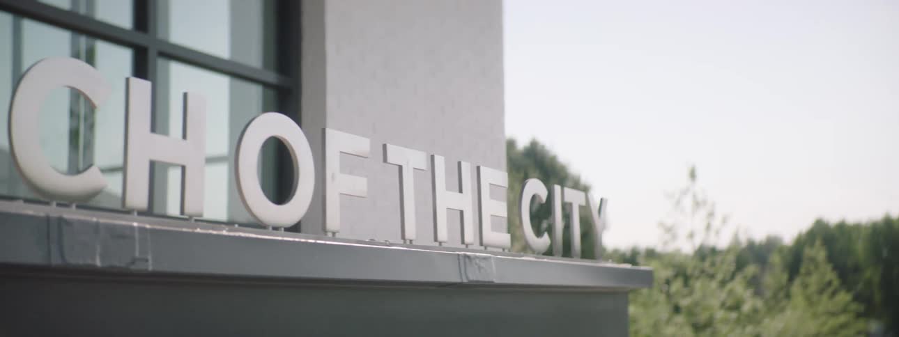 A sign of metal letters writing on a building