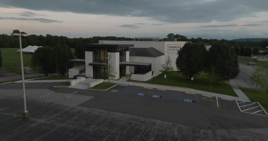 Aerial view of a modern building with a large parking lot