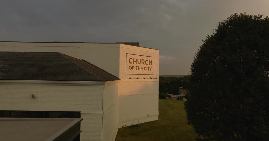 Aerial view of the sign of a modern church on the side of a building complex