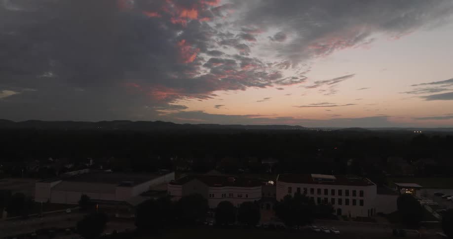 Dusk falls over a city near mountains