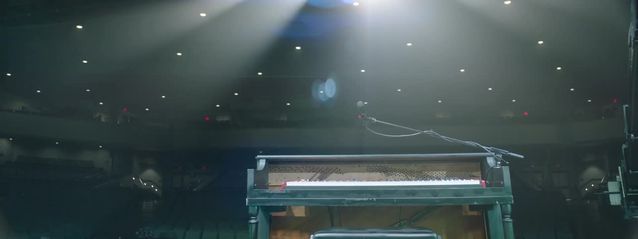A large piano is on the stage