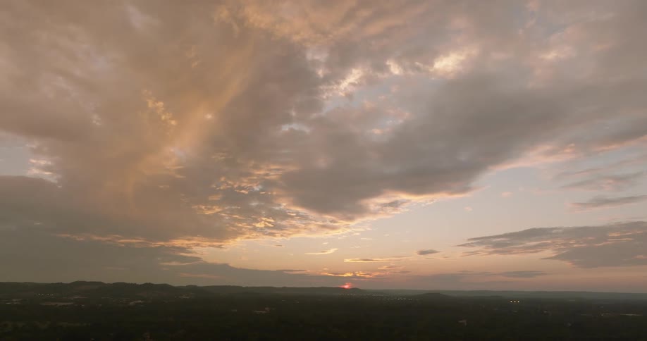 The sun is rising on a cloudy day