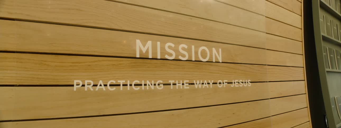 Close up of a sign for a modern christian church inside a building