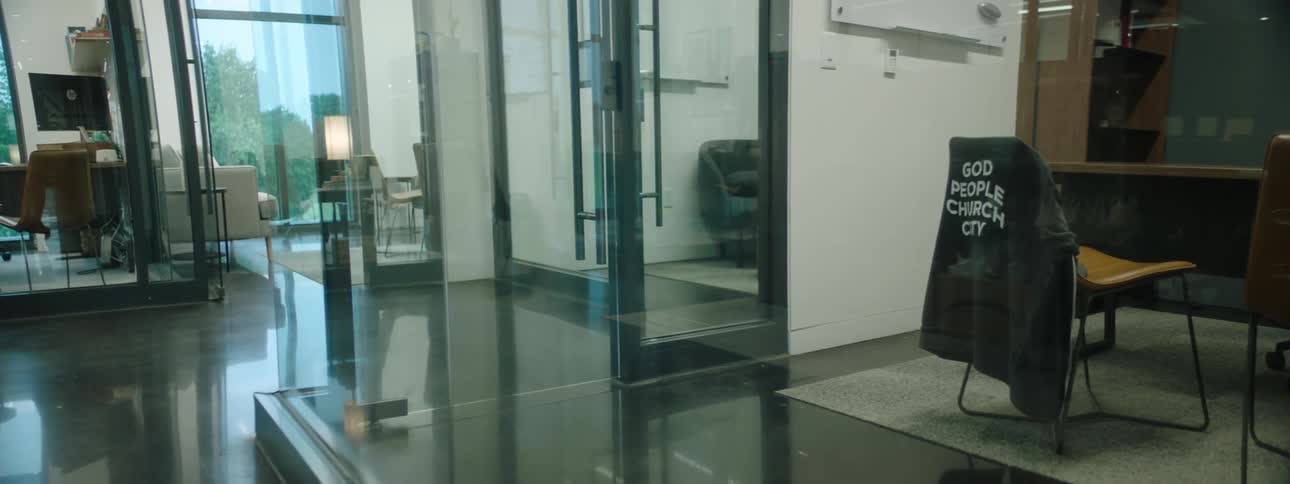 Touring a modern church with glasswalled offices