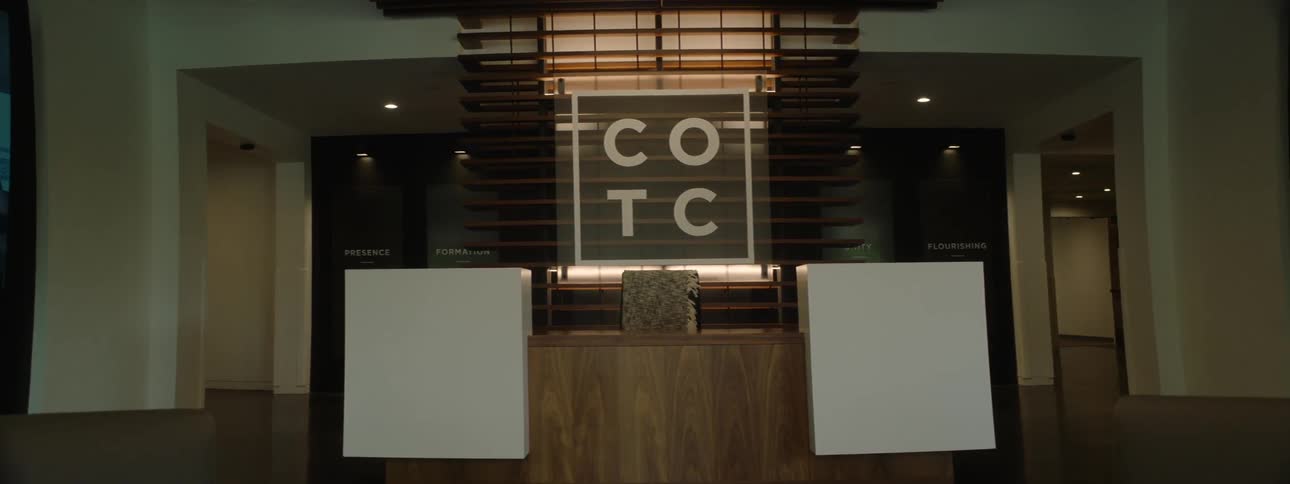 Interior design with led lighting ceiling in a reception with a wooden bench and digital screens on the sides