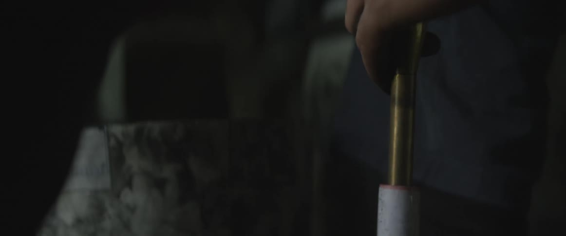 Man pours something into a pipe and shoves it in