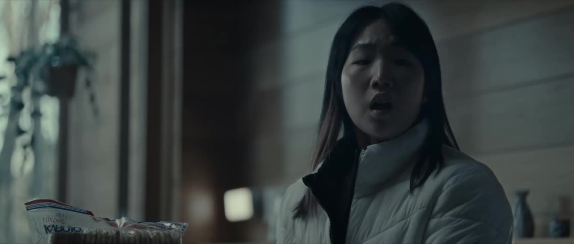 An asian woman expresses surprise when she turns her head and sees something