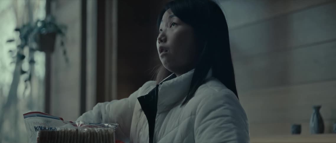 Woman in the kitchen taking food out of a box
