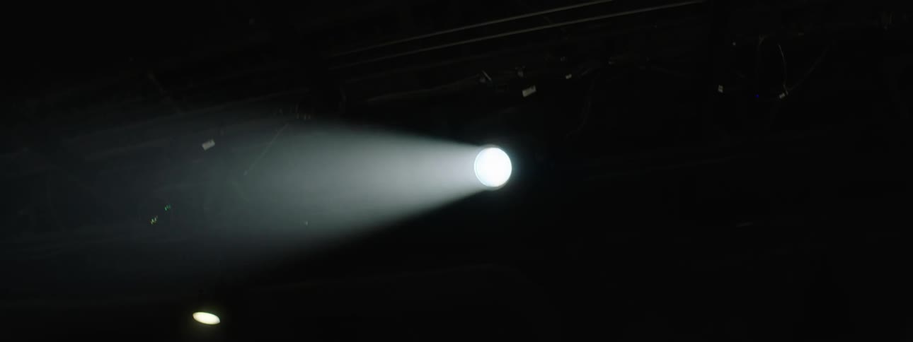 Upward view of lights in a lowlit auditorium