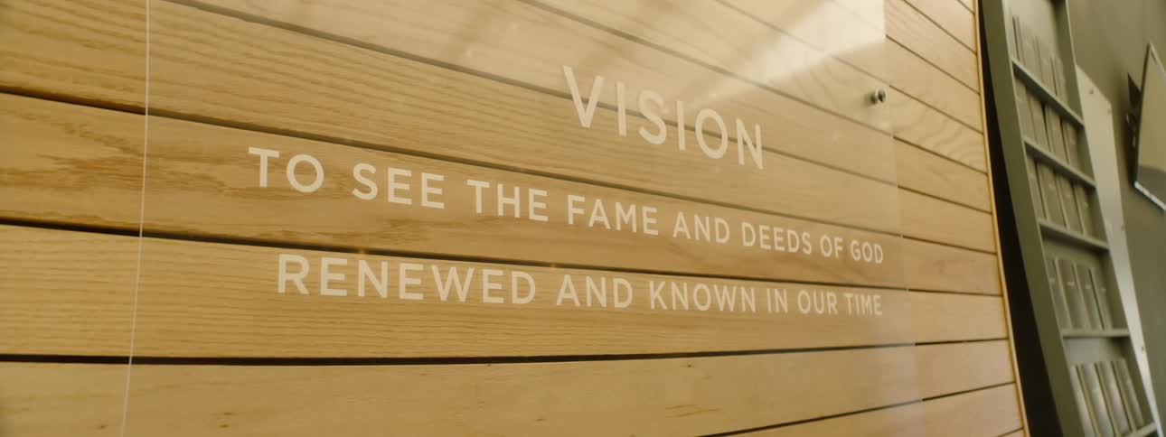 Glass plate fixed to a wooden wall with text written in white